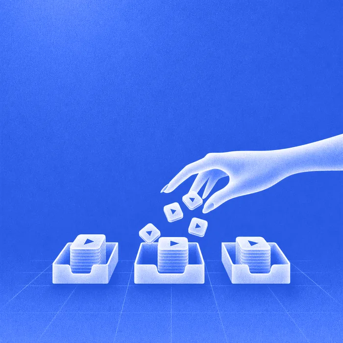 A hand releasing creative tiles that drop into three evenly stacked trays